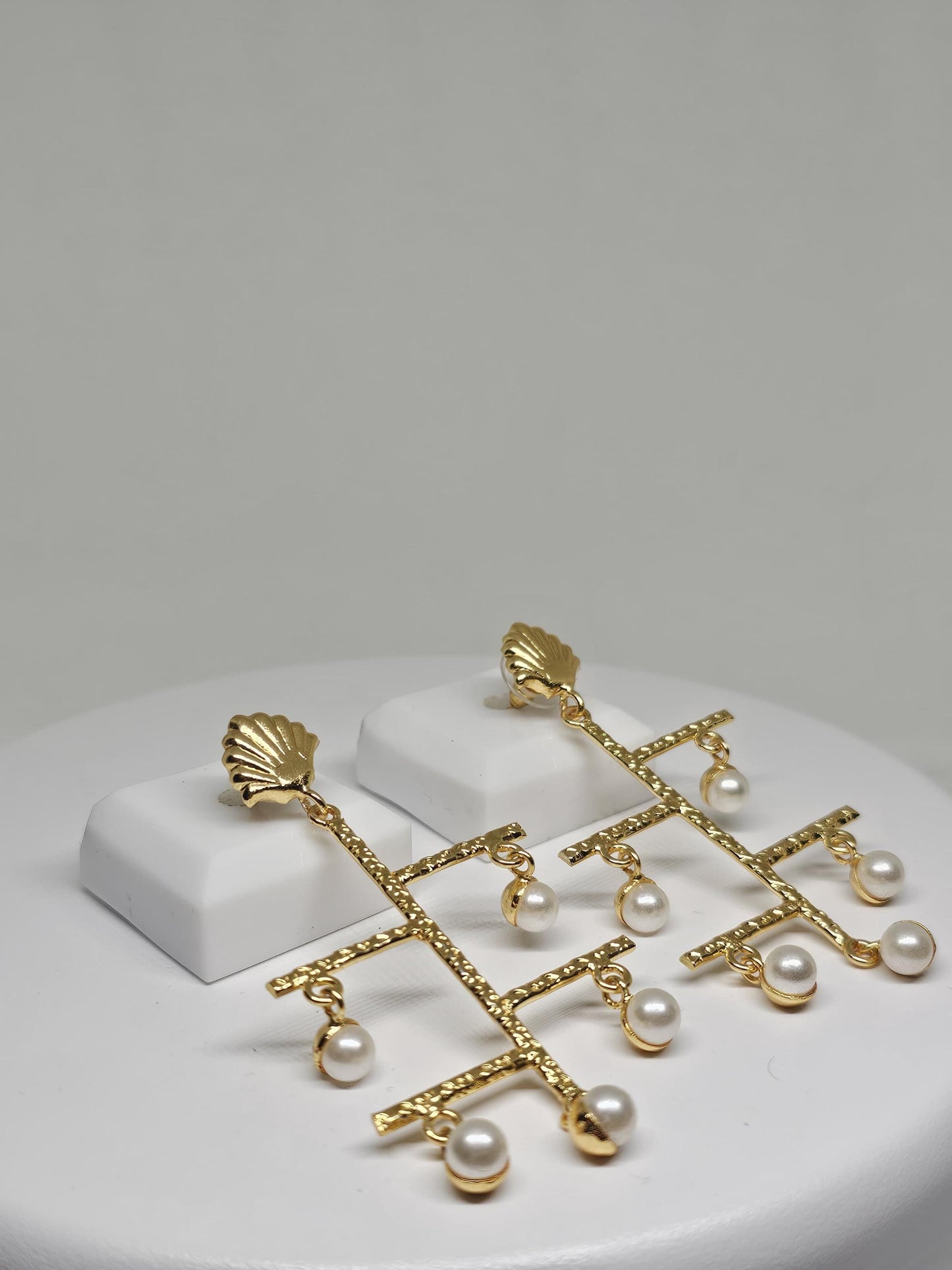 Statement geometric earrings featuring textured gold bars and dangling pearls, perfect for festive and wedding occasions