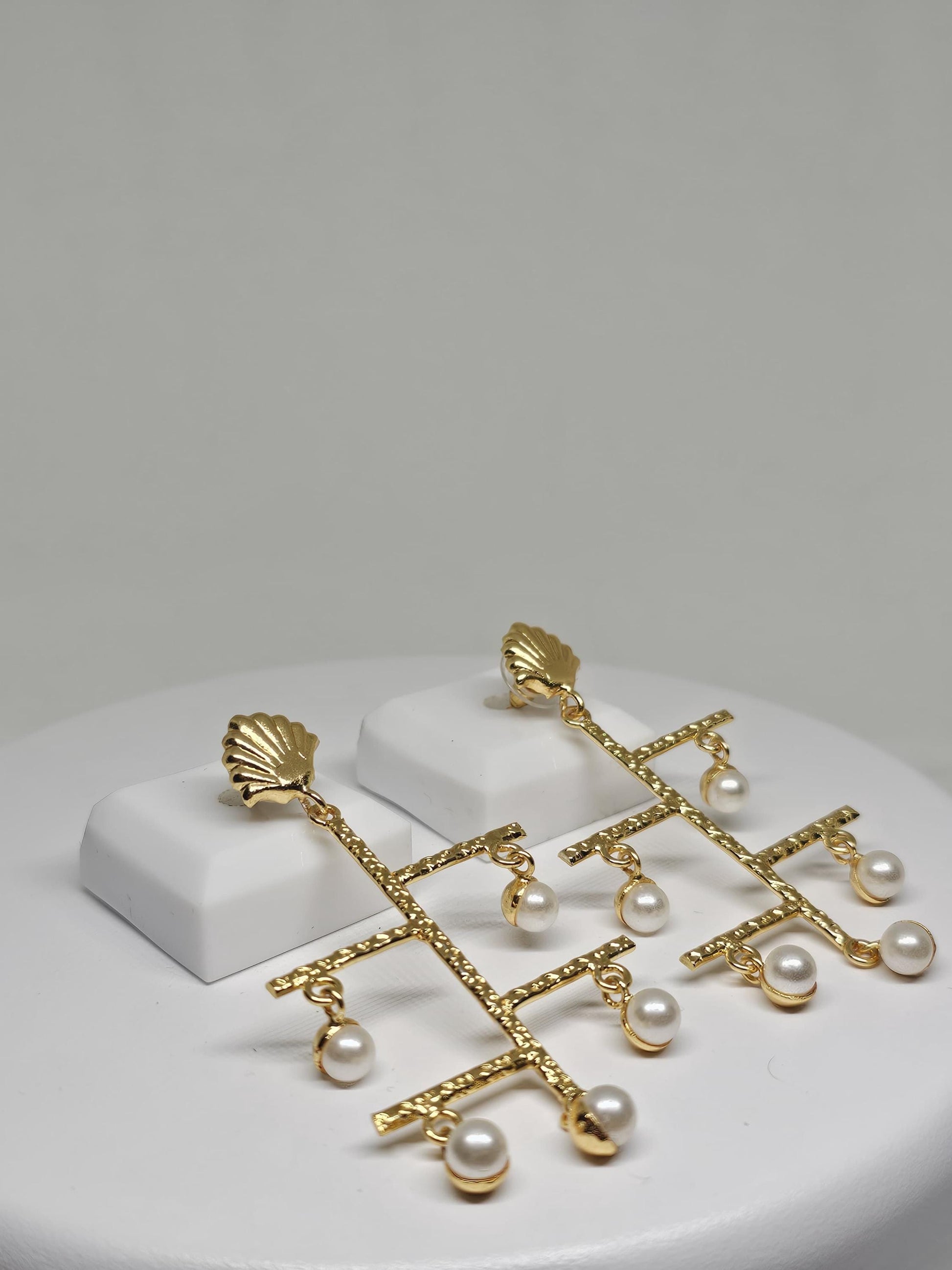 Statement geometric earrings featuring textured gold bars and dangling pearls, perfect for festive and wedding occasions