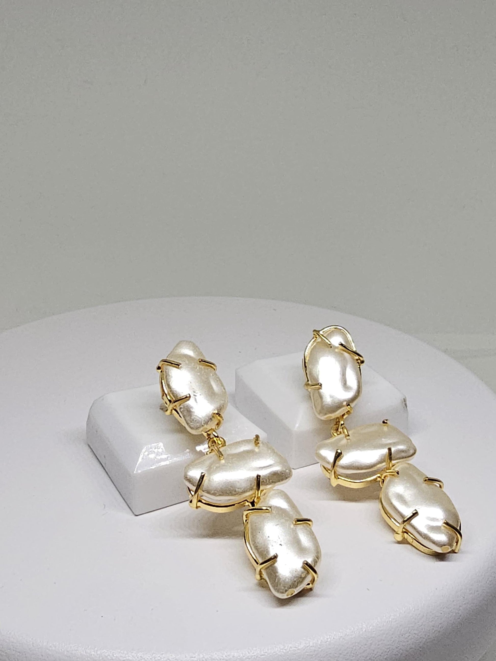 Timeless drop earrings with natural mother of pearl stones, secured in artistic gold-plated wire frames, perfect for formal occasions