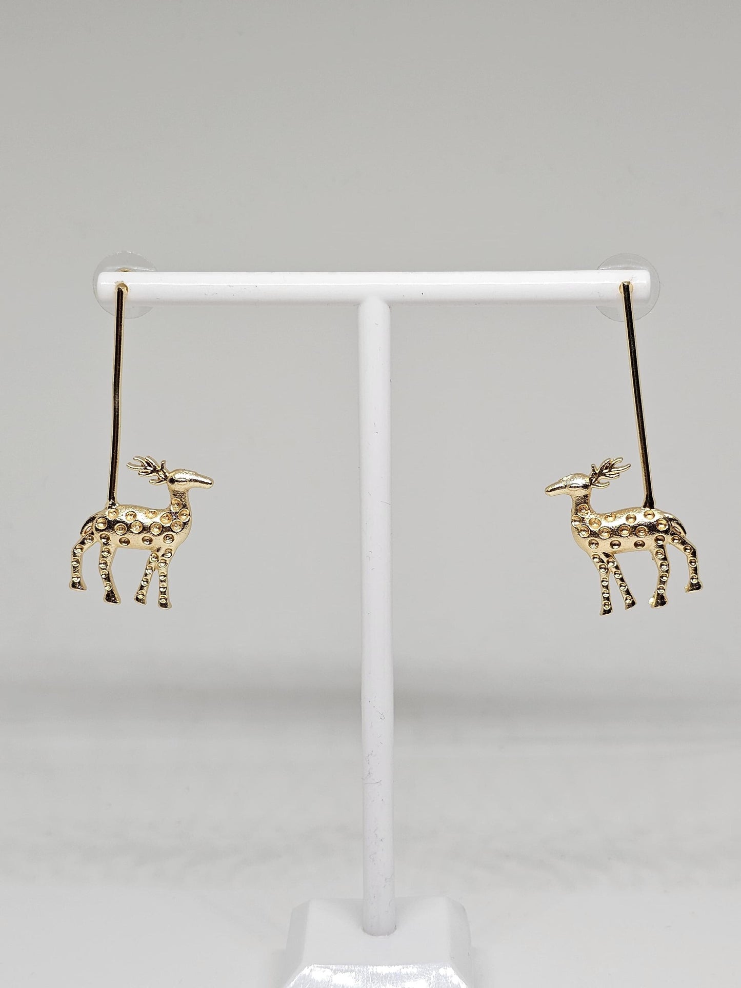 Golden reindeer dangle earrings with a minimalist bar design, crafted for festive occasions and Christmas celebrations. Perfect holiday gift for women