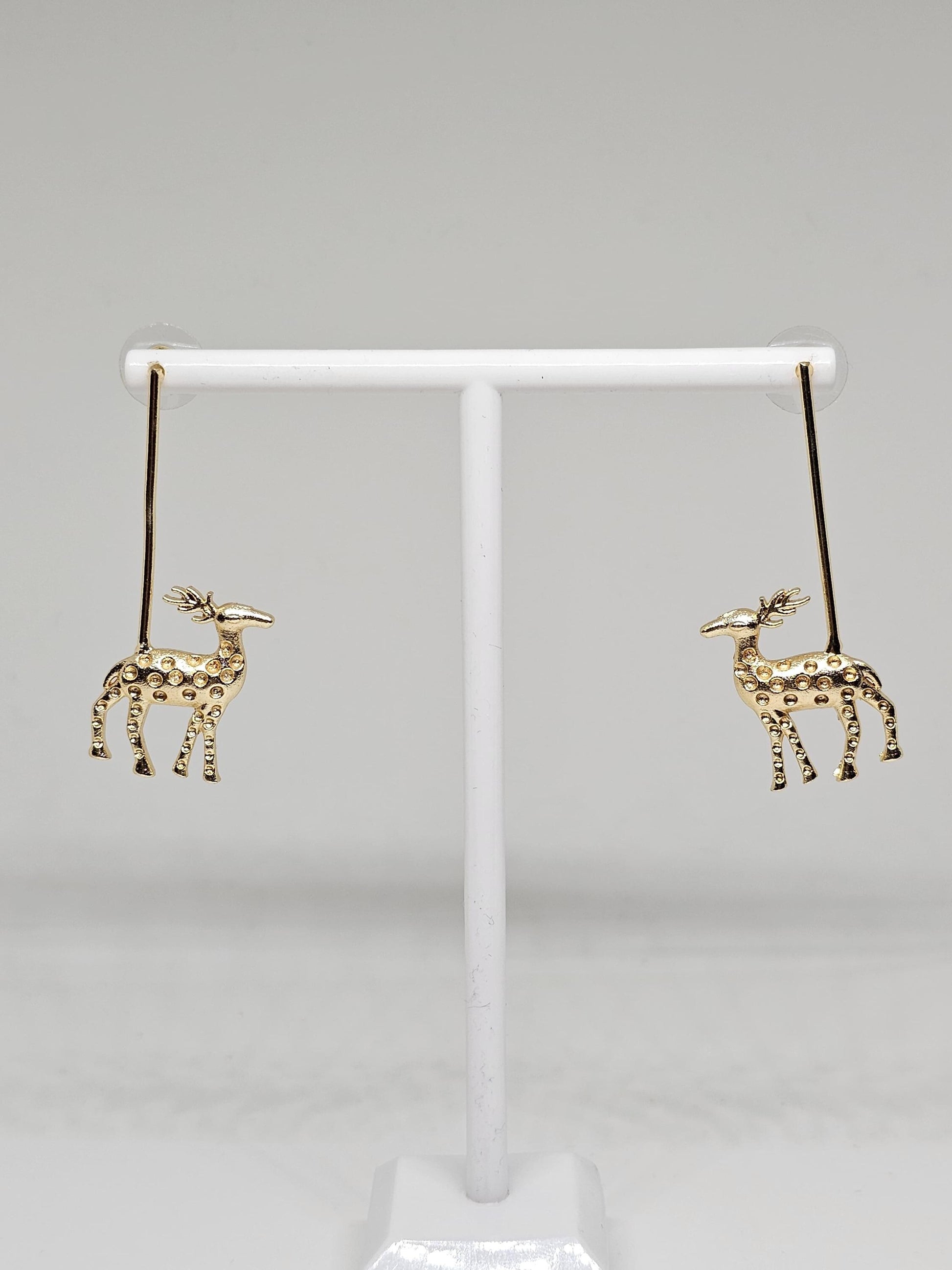 Golden reindeer dangle earrings with a minimalist bar design, crafted for festive occasions and Christmas celebrations. Perfect holiday gift for women