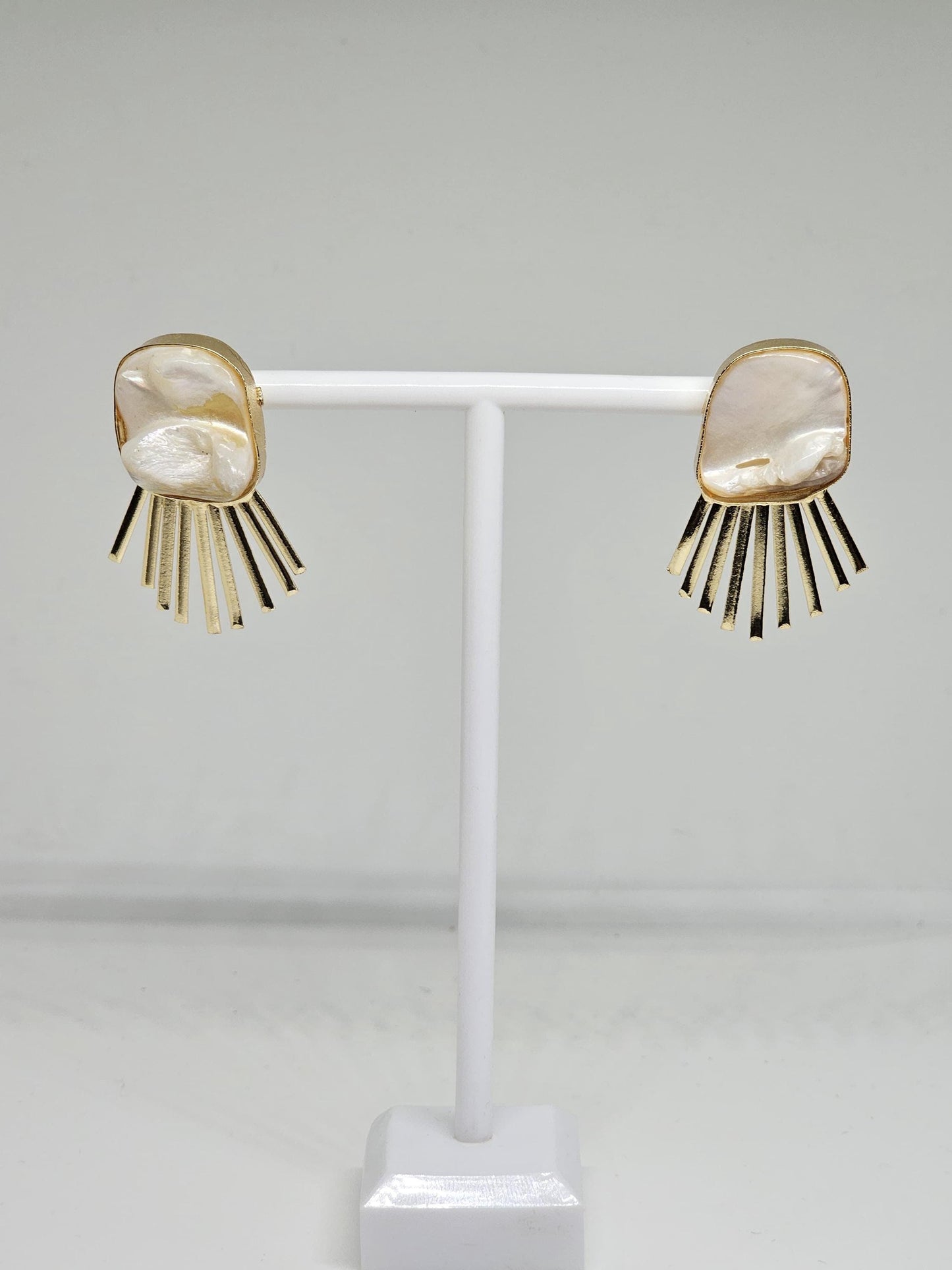 Minimalist pearl-inspired brass earrings featuring a radiant sunray design, perfect for modern and elegant looks