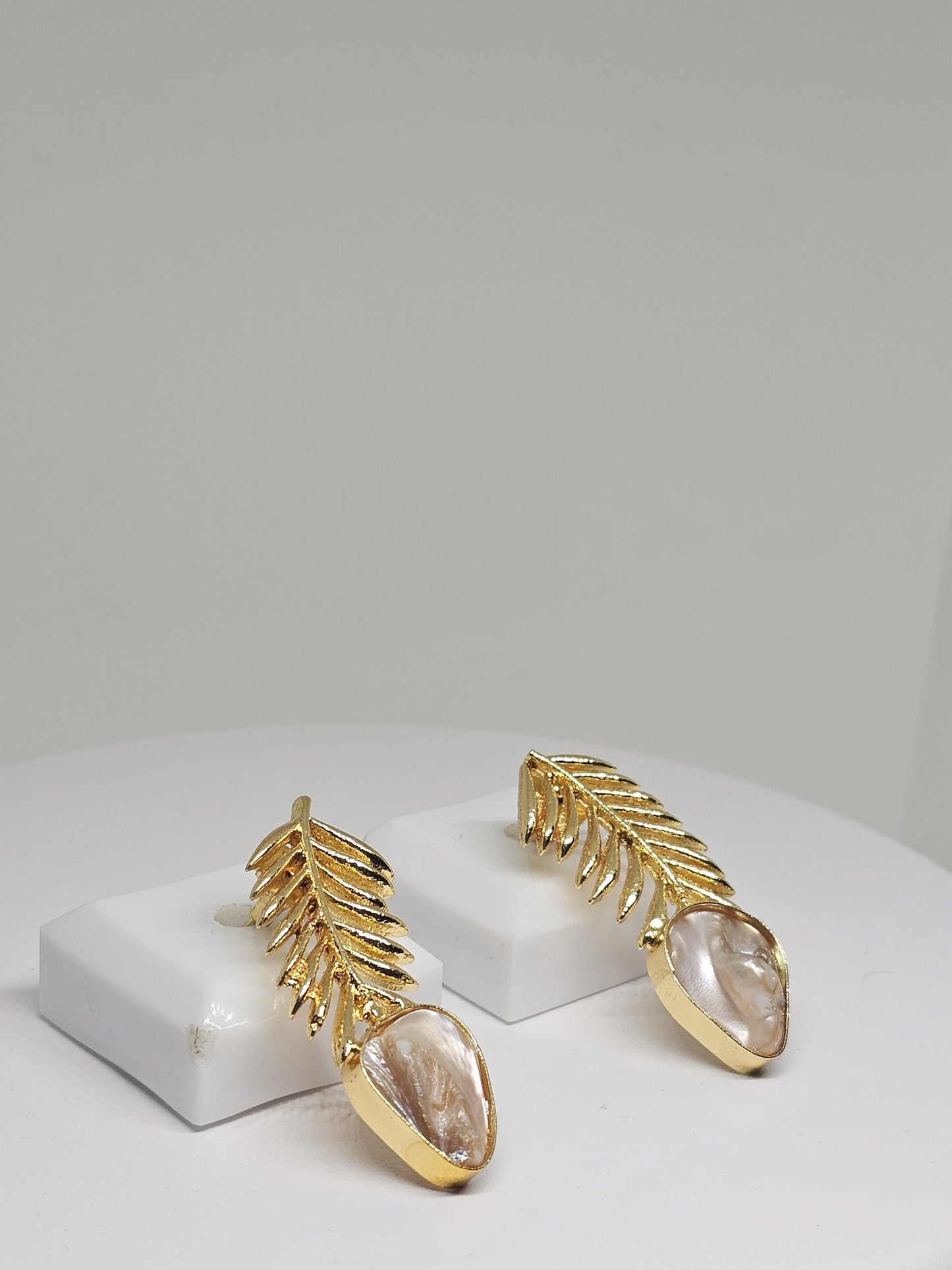 Elegant gold leaf earrings with a natural mother-of-pearl drop, featuring a lightweight and intricate design perfect for women seeking unique handmade jewelry
