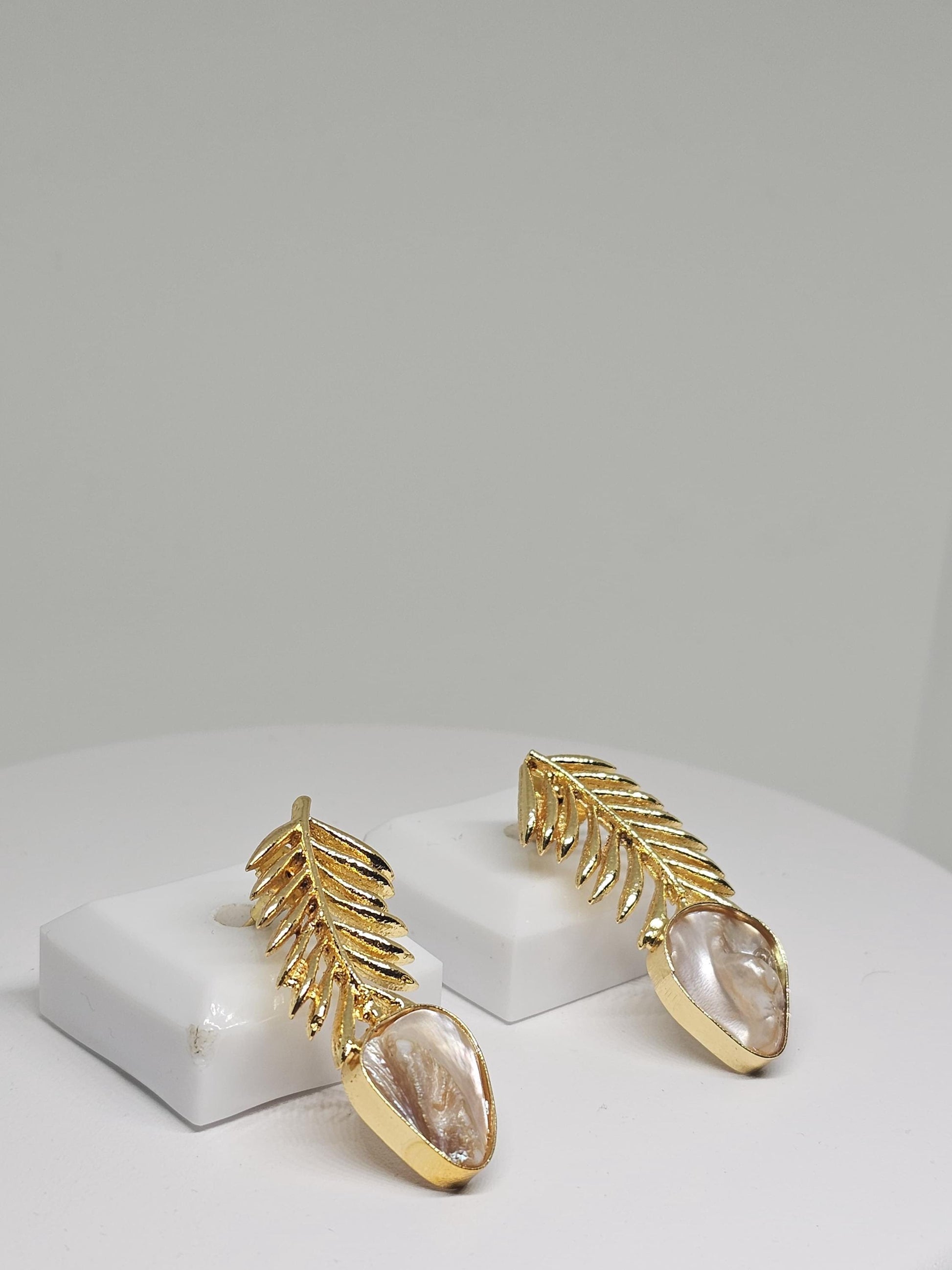 Elegant gold leaf earrings with a natural mother-of-pearl drop, featuring a lightweight and intricate design perfect for women seeking unique handmade jewelry