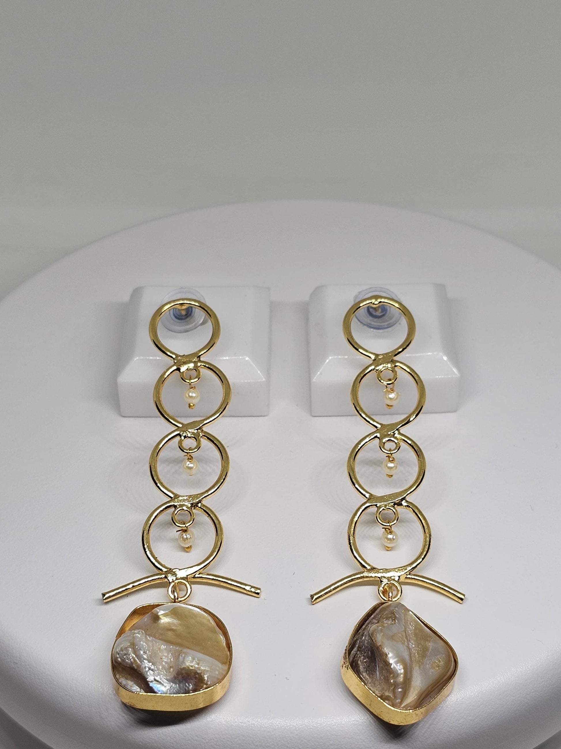 Contemporary geometric earrings in gold featuring a sleek bar design, tiny pearl details, and a lustrous mother-of-pearl stone for a bold yet refined look