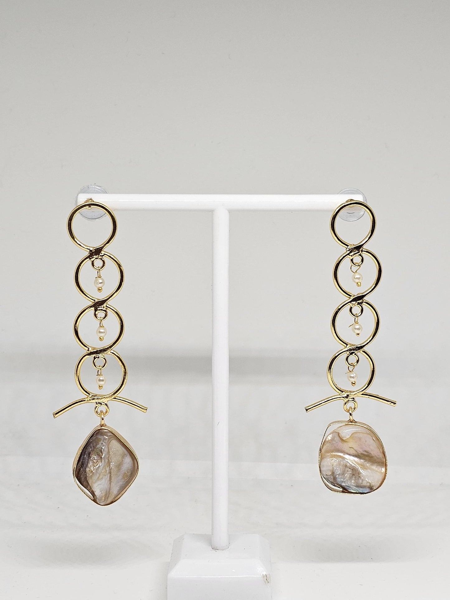 Sophisticated gold-tone drop earrings featuring a modern circular design, delicate pearl accents, and a stunning mother-of-pearl centerpiece for an elegant finish