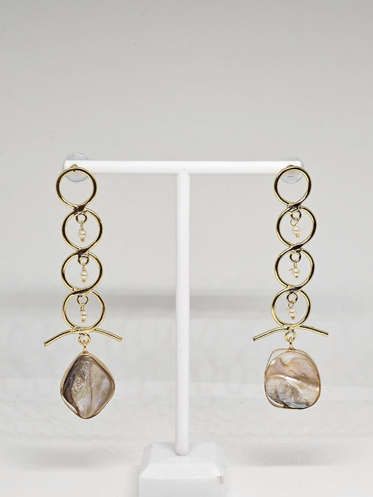 Sophisticated gold-tone drop earrings featuring a modern circular design, delicate pearl accents, and a stunning mother-of-pearl centerpiece for an elegant finish