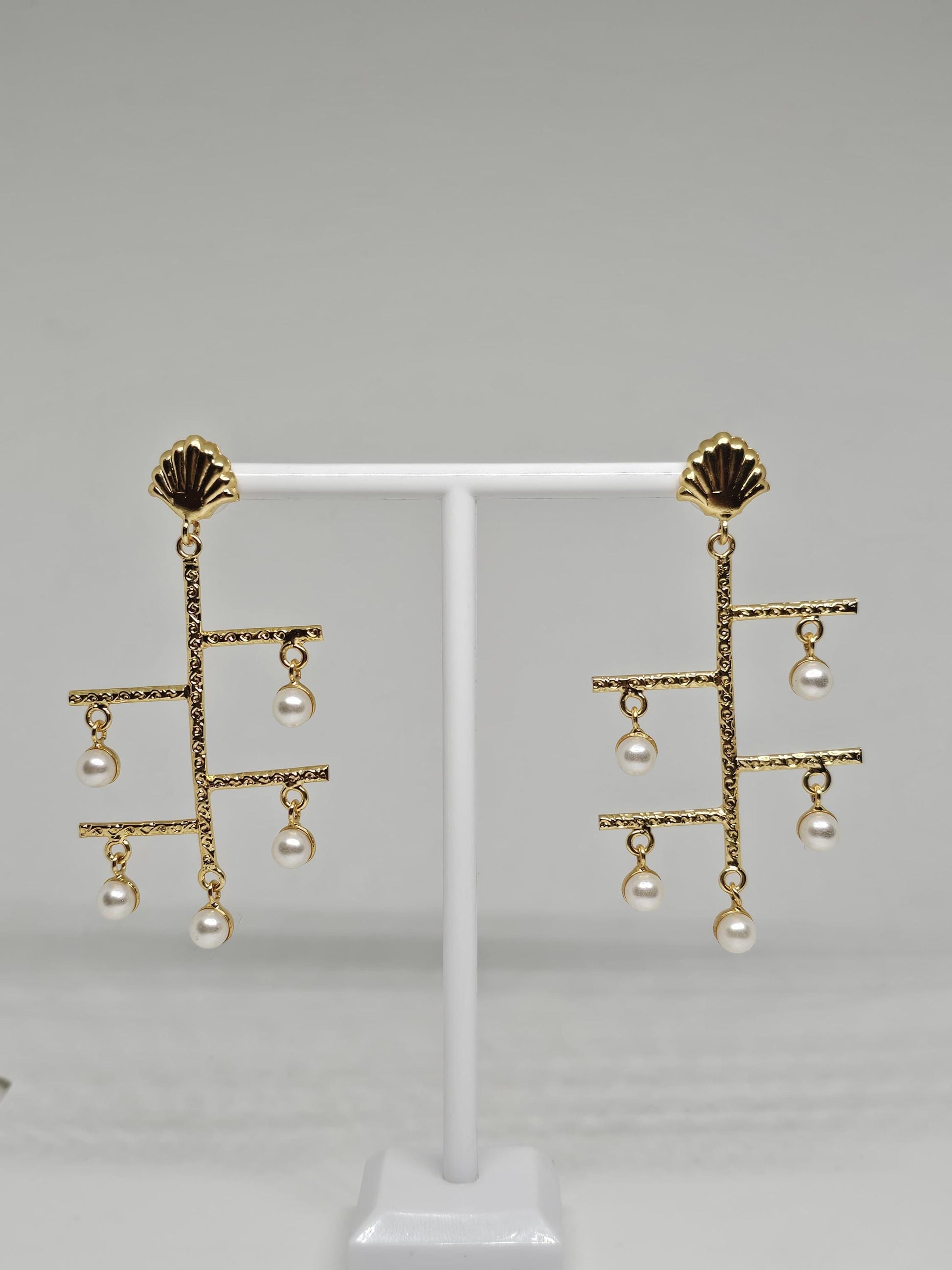 Modern gold-plated dangle earrings with geometric design and faux pearl drops, complemented by shell-inspired studs for elegance
