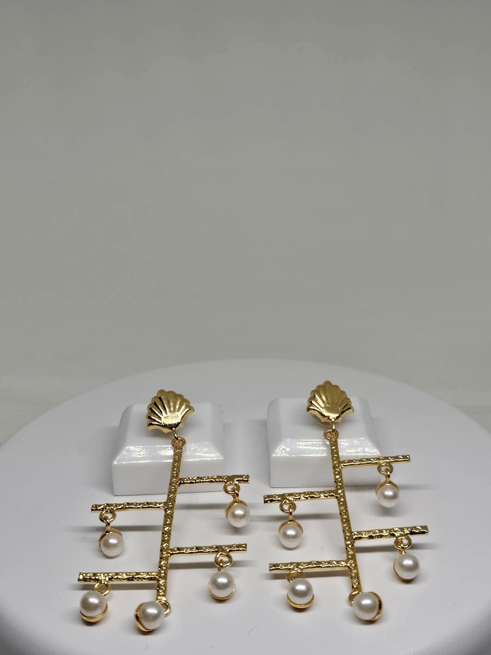 Unique shell-stud earrings with cascading faux pearls and a lightweight geometric design for artistic flair