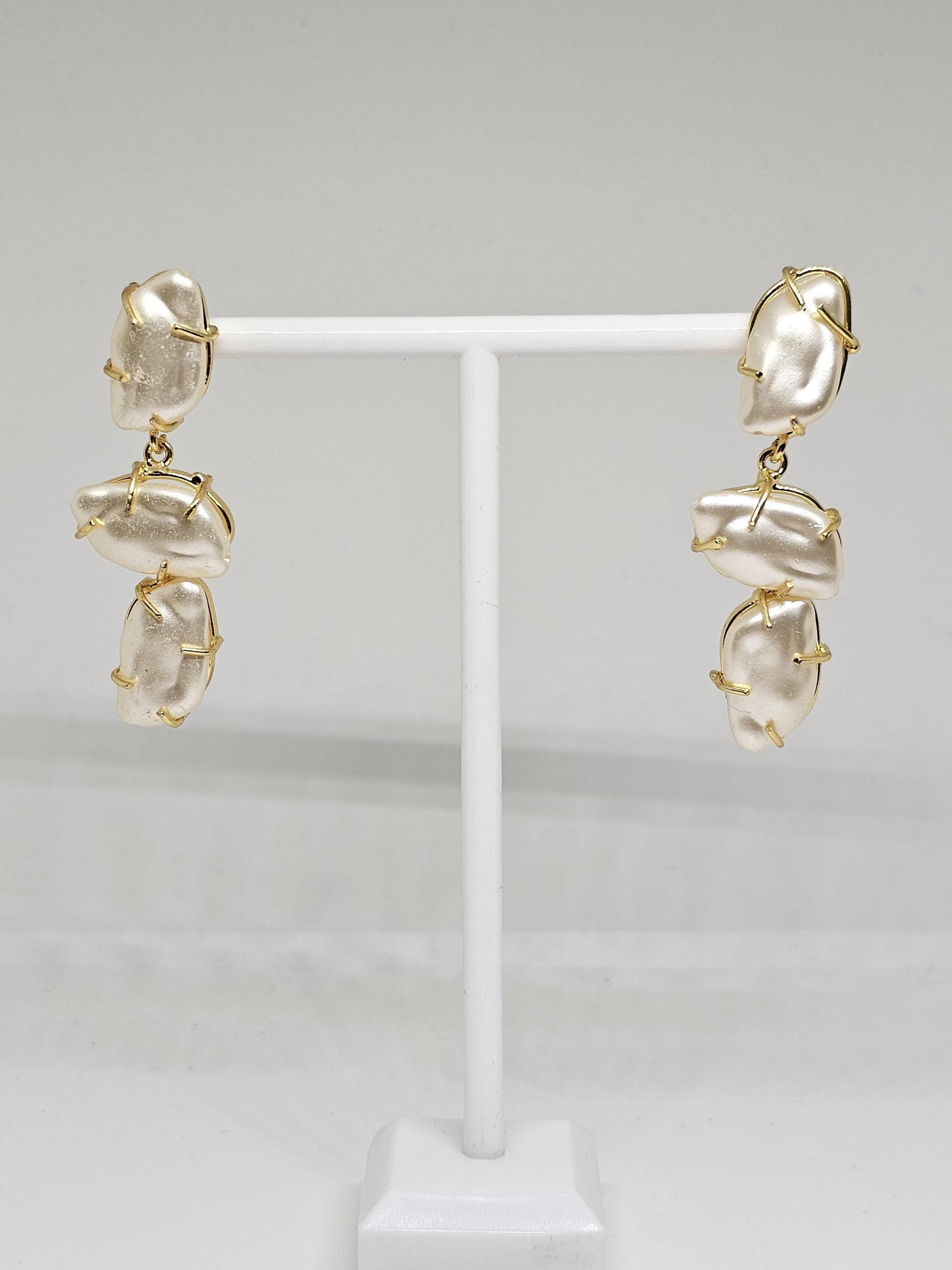 Elegant mother of pearl dangle earrings featuring gold-plated wire detailing for a unique and modern jewelry design