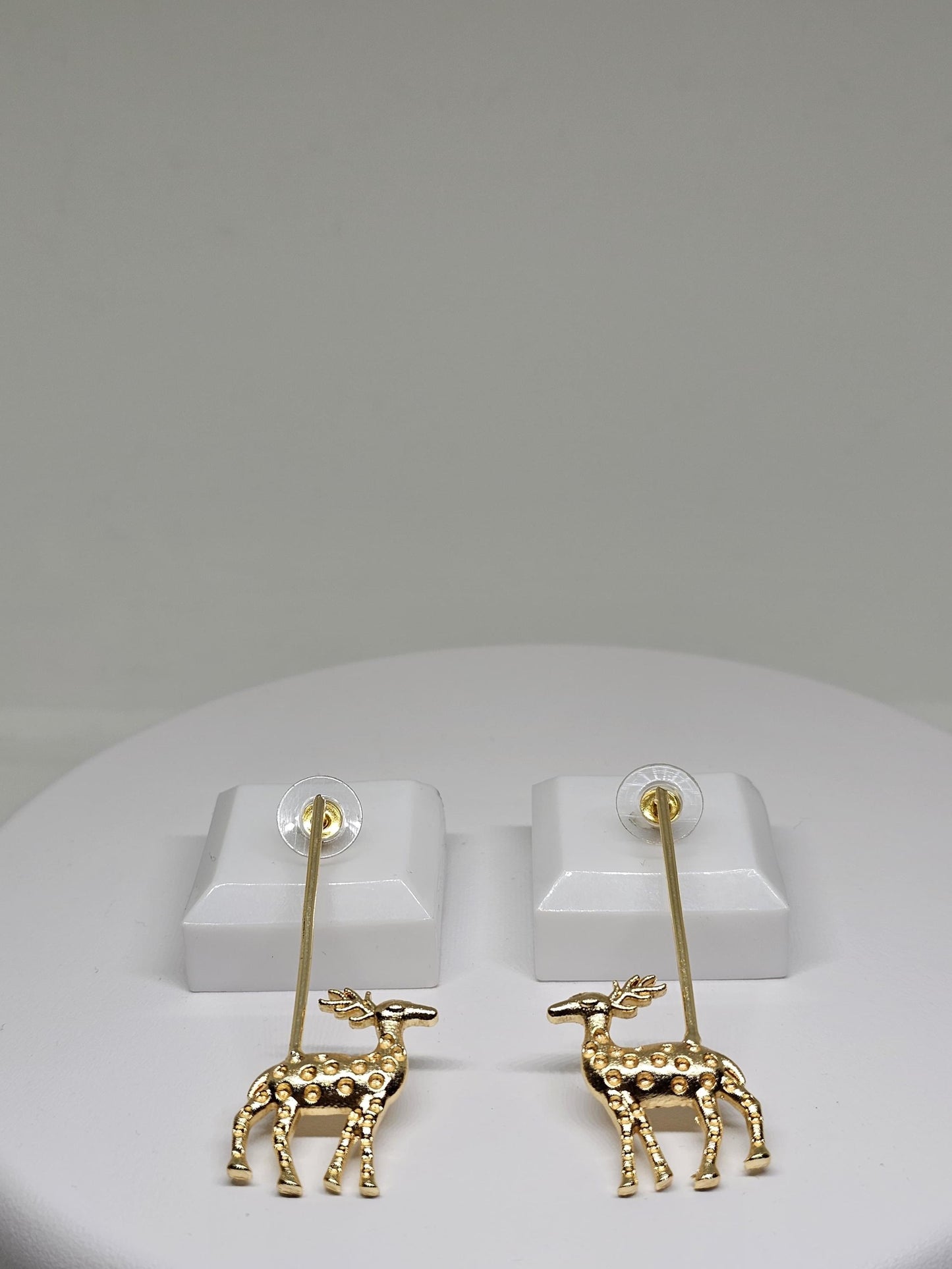 Golden reindeer dangle earrings with a minimalist bar design, crafted for festive occasions and Christmas celebrations. Perfect holiday gift for women