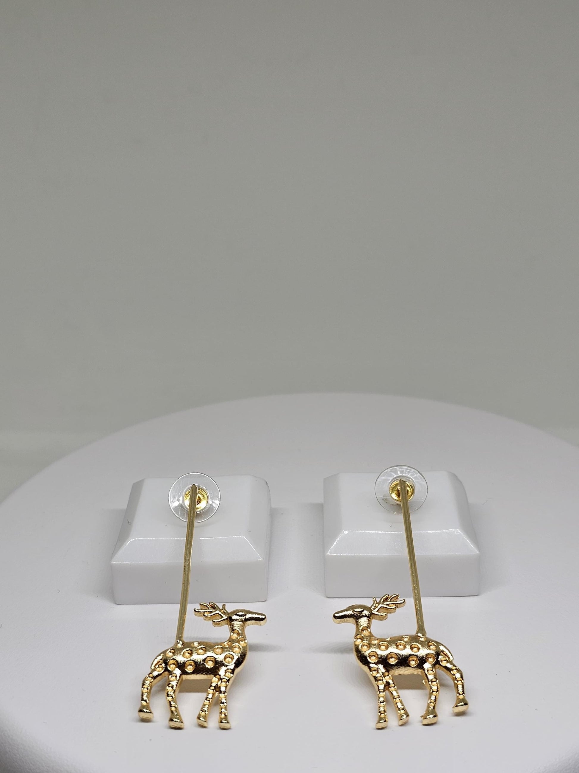 Golden reindeer dangle earrings with a minimalist bar design, crafted for festive occasions and Christmas celebrations. Perfect holiday gift for women