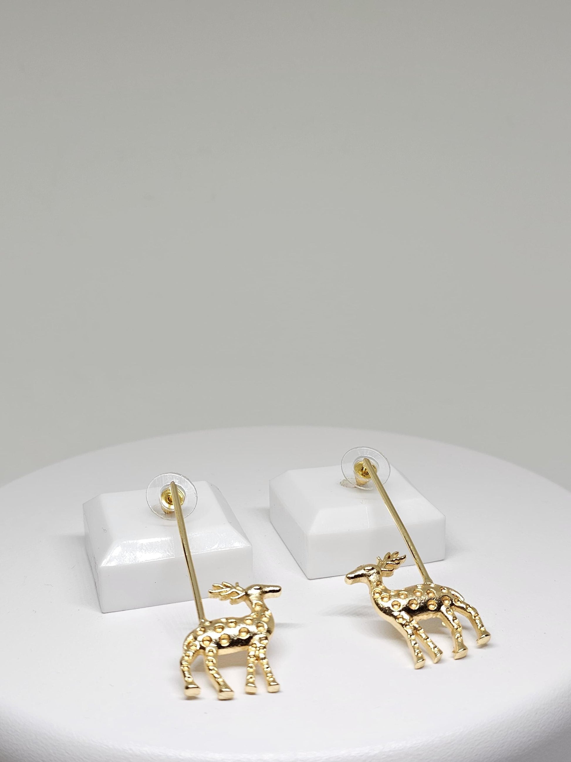 Golden reindeer dangle earrings with a minimalist bar design, crafted for festive occasions and Christmas celebrations. Perfect holiday gift for women