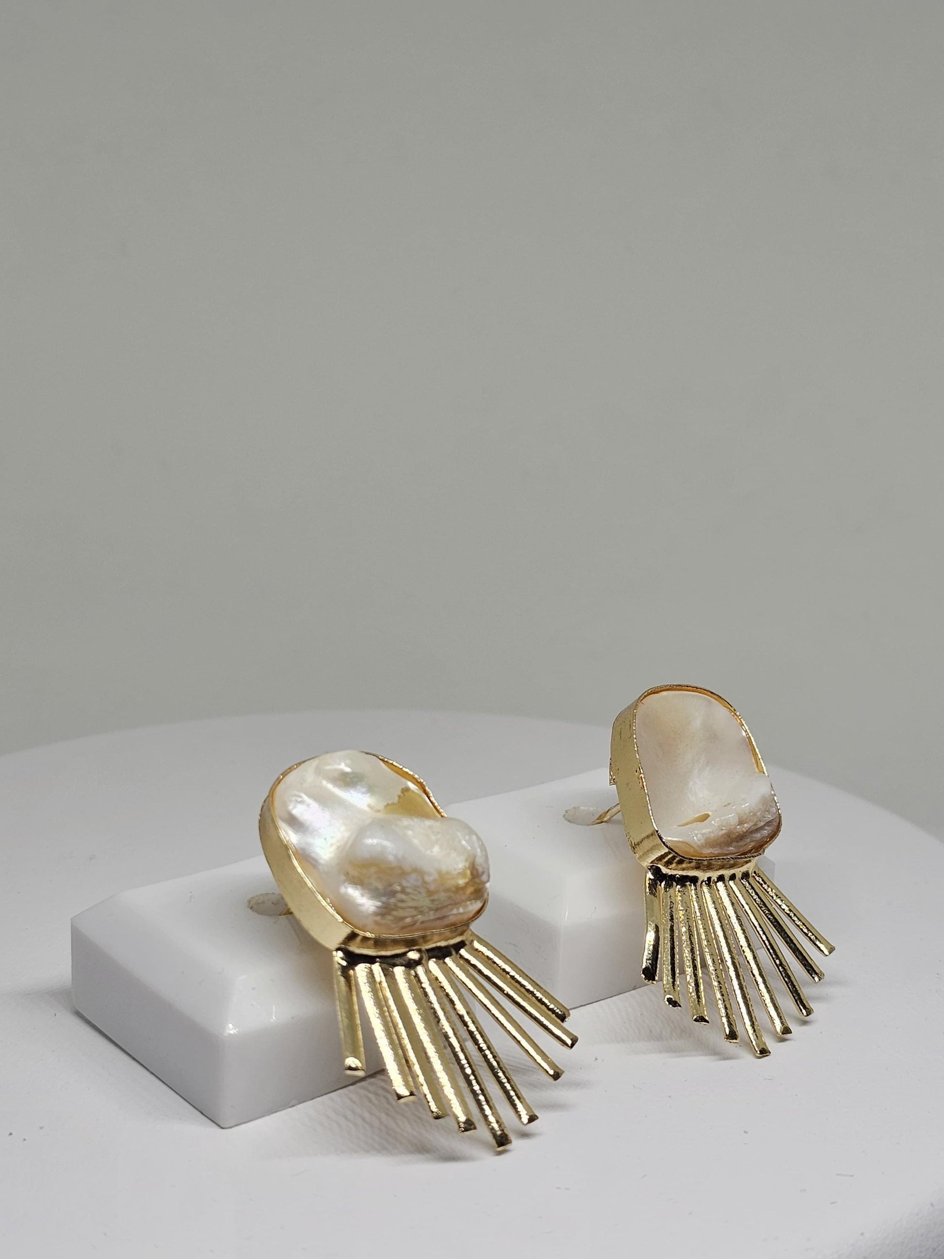 Minimalist pearl-inspired brass earrings featuring a radiant sunray design, perfect for modern and elegant looks