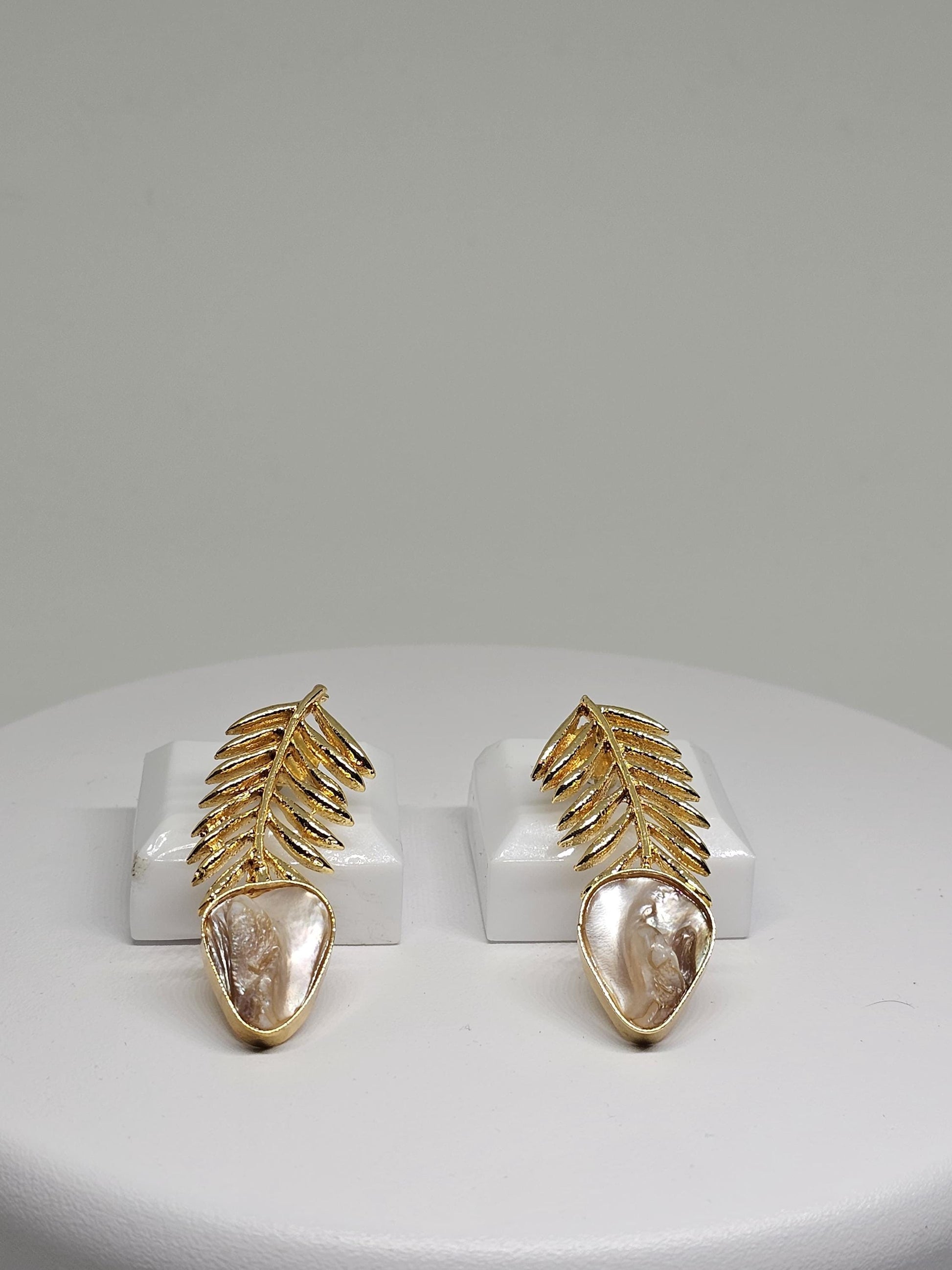 Elegant gold leaf earrings with a natural mother-of-pearl drop, featuring a lightweight and intricate design perfect for women seeking unique handmade jewelry