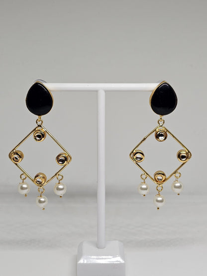 Close-up of black and gold chandelier earrings